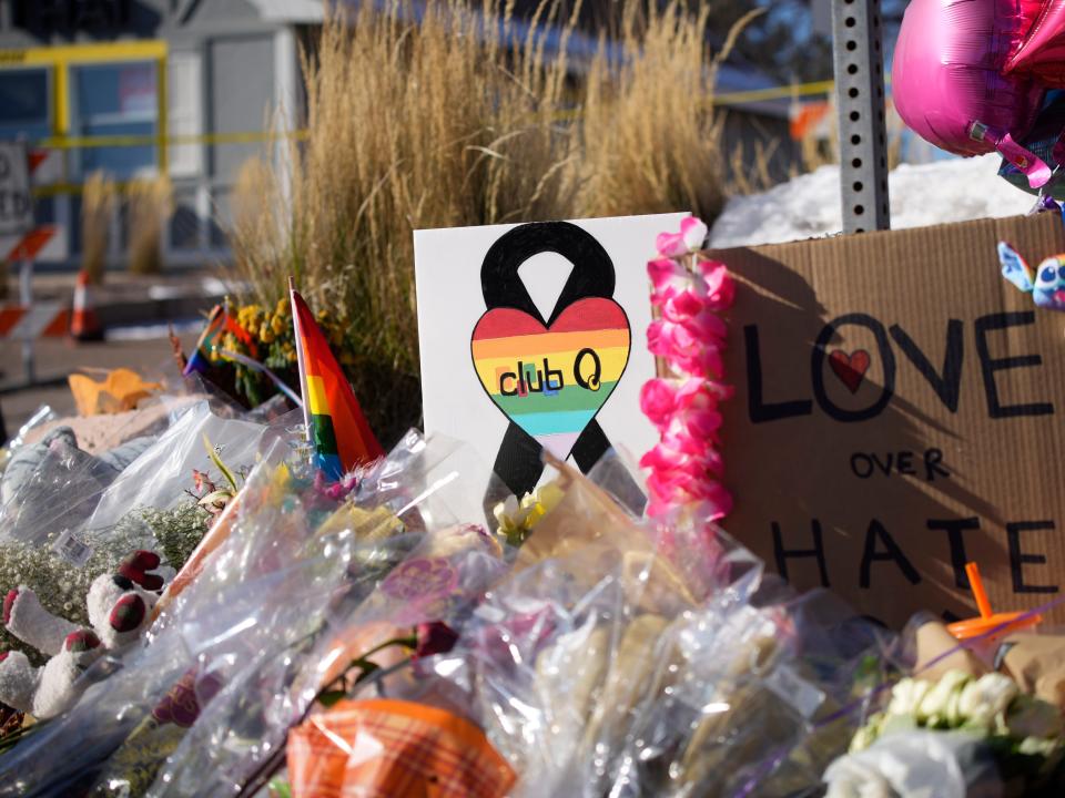 Flowers and signs for a memorial for Club Q victims.