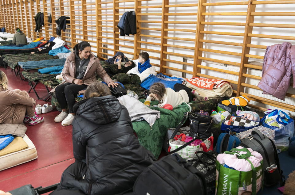 Refugees from Ukraine rest inside the help center of Beregsurany, near the Hungarian-Ukrainian border, Hungary, Wednesday, March 16, 2022. (Attila Balazs/MTI via AP)