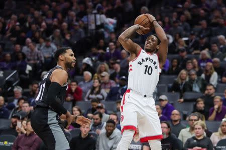 Dec 10, 2017; Sacramento, CA, USA; Toronto Raptors guard DeMar DeRozan (10) shoots the ball against Sacramento Kings guard Garrett Temple (17) during the first quarter at Golden 1 Center. Mandatory Credit: Sergio Estrada-USA TODAY Sports