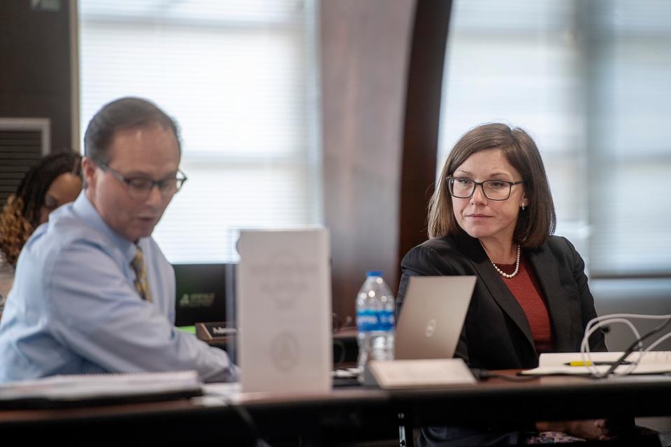 Asheville City Schools Superintendent Maggie Fehrman listens as Board Attorney Chris Campbell discusses the ramifications of a new North Carolina law August 1, 2023.
