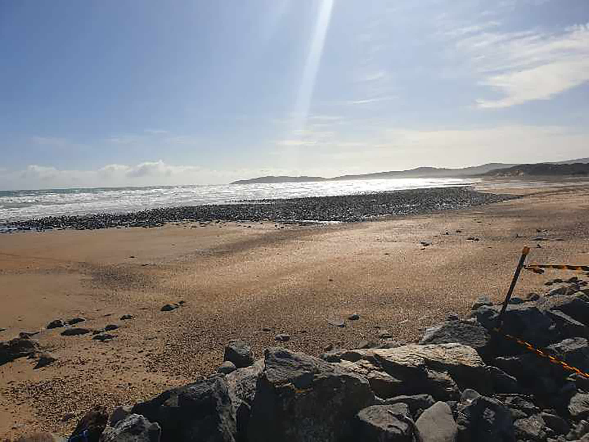 The sun shining down on Badger Beach in Narawntapu National Park. The uncovered area can be seen in the distance.