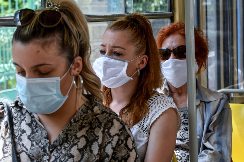 Passengers travel wearing facemasks on a tram in Zagreb on June 25, 2020, as the wearing of masks on public transport in Croatia became mandatory on June 23, due to an increase of coronavirus infections after the relaxation of lockdown conditions. (Photo by DENIS LOVROVIC / AFP) (Photo by DENIS LOVROVIC/AFP via Getty Images)