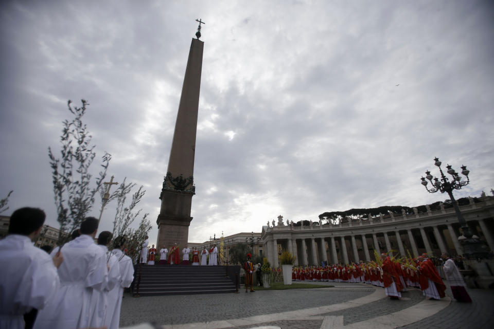 Pope Francis, background center, celebrates a Palm Sunday mass in St. Peter's Square, at the Vatican, Sunday, April 13, 2014. (AP Photo/Gregorio Borgia)