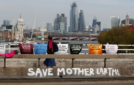 A person walks across Waterloo Bridge during the Extinction Rebellion protest in London, Britain April 18, 2019. REUTERS/Peter Nicholls