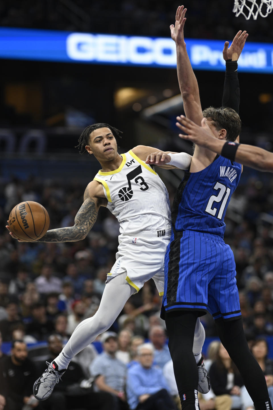 Utah Jazz guard Keyonte George (3) looks to pass the ball as Orlando Magic center Moritz Wagner (21) defends during the second half of an NBA basketball game, Thursday, Feb. 29, 2024, in Orlando, Fla. (AP Photo/Phelan M. Ebenhack)