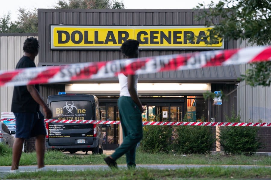 Pedestrians walk past a Dollar General store where three people were shot and killed the day before, on Aug. 27, 2023, in Jacksonville, Florida. Police say that the attack by a gunman on Black customers at the store is being investigated as a hate crime. (Photo by Sean Rayford/Getty Images)