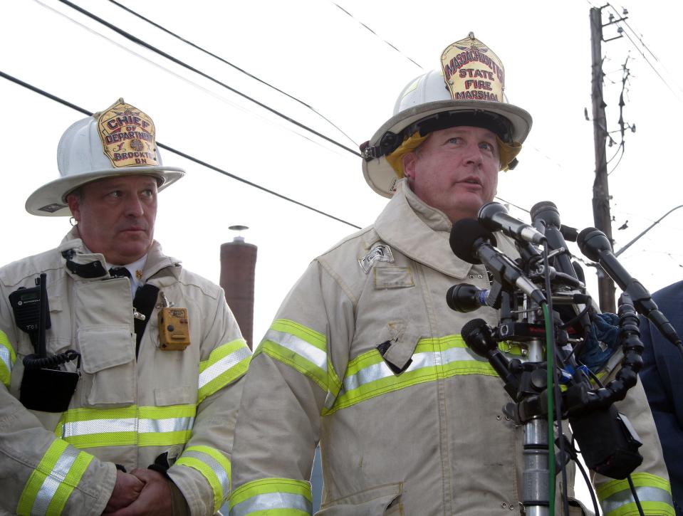 Massachusetts State Fire Marshal Peter Ostroskey answers questions from the media at the site of a 10-alarm fire at Signature Healthcare Brockton Hospital on Tuesday, Feb. 7, 2023. Brockton Fire Chief Brian Nardelli, left, looks on.