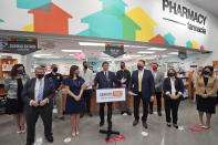 Flanked by other elected officials, Florida Gov. Ron DeSantis, center, gestures as he speaks during a news conference, Tuesday, Feb. 23, 2021, at a Navarro Discount Pharmacy in Hialeah, Fla. DeSantis announced that seniors will soon be able to receive COVID-19 vaccinations at Navarro Discount Pharmacies and CVS y mas pharmacies in Miami-Dade County. (AP Photo/Wilfredo Lee)