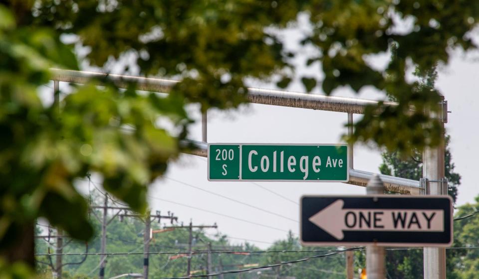 A one way sign hangs under the College Avenue sign on Wednesday, June 8, 2023.