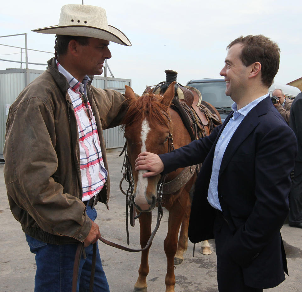 Russian Prime Minister Dmitry Medvedev, right, speaks with a farmer as he visits cattle breeding farm Kotlyakovo in Bryansk region, 380 km (238 miles) southwest of Moscow, Russia, Wednesday, May 23, 2012. (AP Photo/RIA-Novosti, Yekaterina Shtukina, Presidential Press Service).