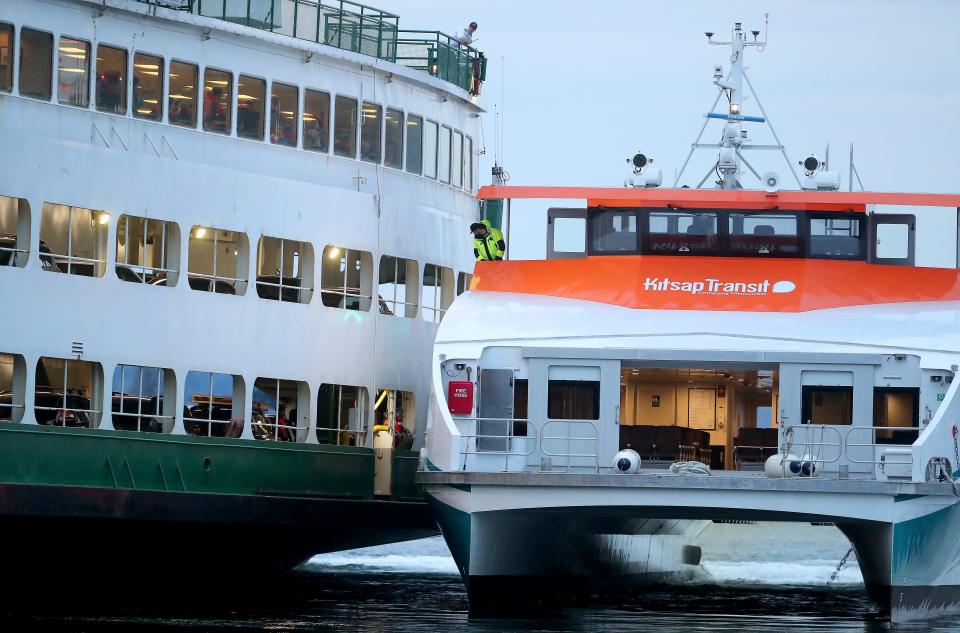 A Kitsap Transit passenger ferry docks along the Washington State Ferries vessel Walla Walla to transfer passengers after the Walla Walla ran aground while transiting Rich Passage and ended up on the shore near Lynwood Center on Bainbridge Island, Wash. on Saturday, April 15, 2023.