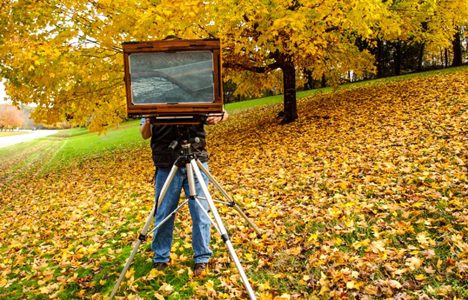 Photographer Sandy King of Easley, S.C. takes down his twenty-by-twelve inch format camera after taking photographs of fall leaves along Perimeter Road in Clemson, S.C. in 2002.   