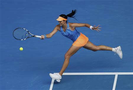 Garbine Muguruza of Spain hits a return to Caroline Wozniacki of Denmark during their women's singles match at the Australian Open 2014 tennis tournament in Melbourne January 18, 2014. REUTERS/Brandon Malone