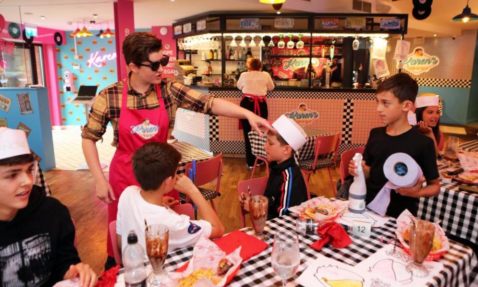 A member of staff makes child customers clean up at Karen’s Diner in Prestwich.