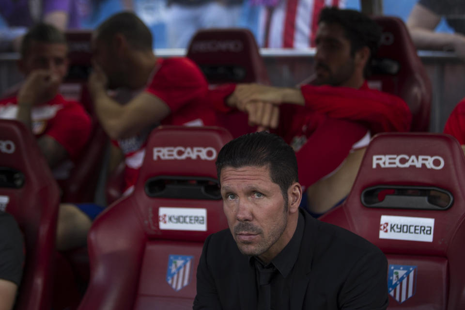 Atletico's coach Diego Simeone sits before a Spanish La Liga soccer match between Atletico de Madrid and Elche at the Vicente Calderon stadium in Madrid, Spain, Friday, April 18, 2014. (AP Photo/Gabriel Pecot)