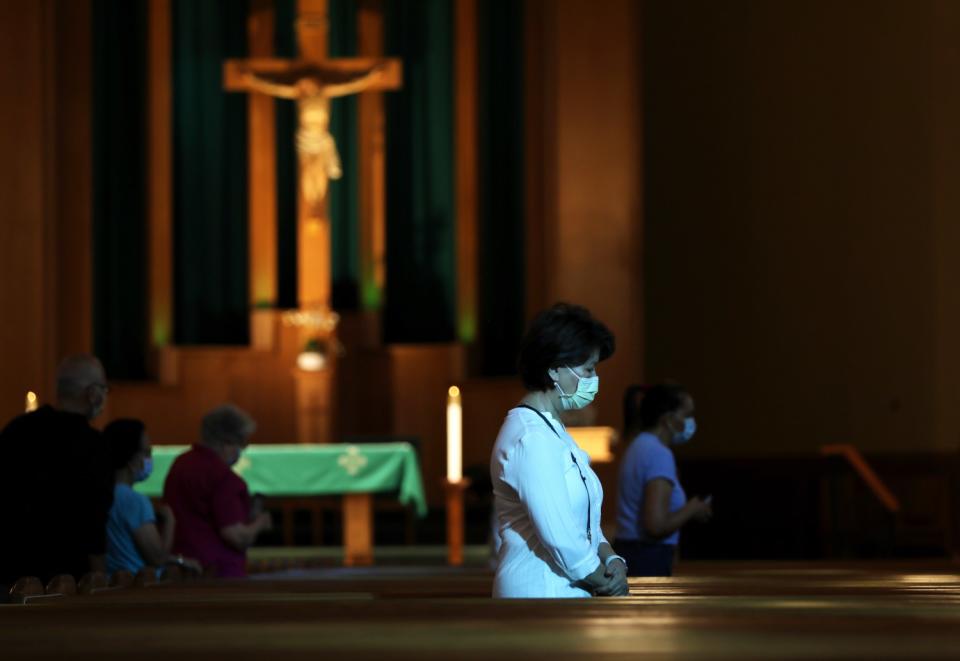 Parishioners attend mass at San Gabriel Mission Church in San Gabriel.