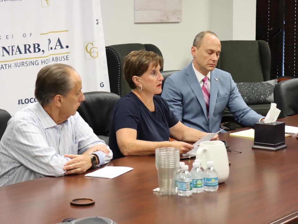 Jodi Mottola (center) discusses the lawsuit she said she will file against Dr. Jack Miletic on Monday, May 9, 2022, in West Palm Beach. Her attorney, Spencer Kuvin, is at right and her husband, David, is at left.