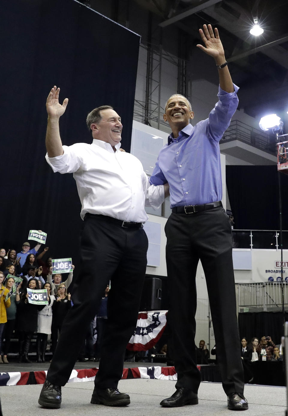 CORRECTS TO SAY THAT DONNELLY IS A CONGRESSIONAL CANDIDATE, NOT A GUBERNATORIAL CANDIDATE - Former President Barack Obama, right, and Democratic congressional candidate U.S. Sen. Joe Donnelly smile as they wave to the crowd during a campaign rally at Genesis Convention Center in Gary, Ind., Sunday, Nov. 4, 2018. (AP Photo/Nam Y. Huh)