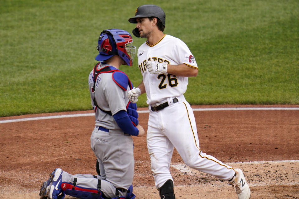 Pittsburgh Pirates' Adam Frazier (26) heads to the dugout past Chicago Cubs catcher Victor Caratini after hitting a solo home run off starting pitcher Alec Mills during the third inning of a baseball game in Pittsburgh, Thursday, Sept. 24, 2020. The Pirates won 7-0.(AP Photo/Gene J. Puskar)