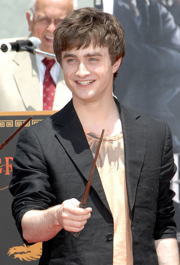 Daniel Radcliffe holds a wand and smiles at  the "Harry Potter and the Order of the Phoenix" - Hand, Footprint and Wand ceremony