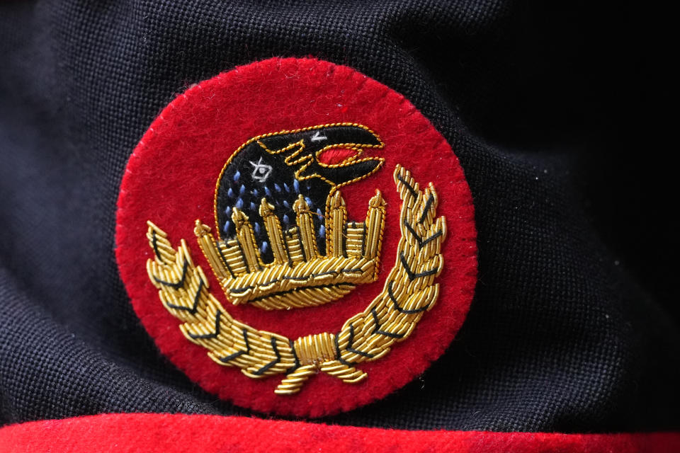 The Ravenmaster 's badge on the uniform of Barney Chandler, newly appointed Raven Master at The Tower of London in London, Thursday, Feb. 29, 2024. If legend is to be believed, Barney Chandler has just got the most important job in England. Chandler is the newly appointed ravenmaster at the Tower of London. He's responsible for looking after the feathered protectors of the 1,000-year-old fortress. (AP Photo/Kirsty Wigglesworth)