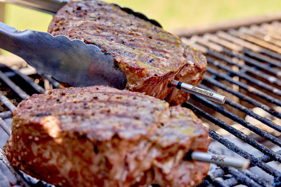 ThermoWorks RFX Meat being uses to sear steaks on a grill.