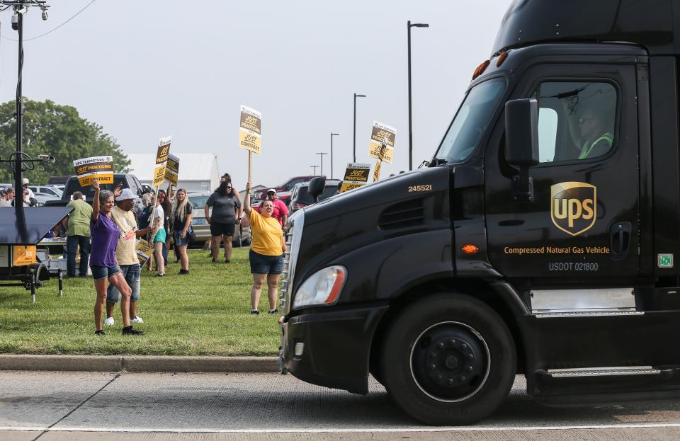 A UPS driver reaches to blow his truck's horn in support as fellow UPS union members hold a practice strike outside Worldport, the largest sorting and logistics facility in America Wednesday morning in Louisville, Ky. The Teamsters Local 89 represents around 10,000 members in Louisville. Teamsters General President Sean O'Brien called for practice pickets nationwide after claiming UPS presented an "appalling economic counterproposal" to the Teamsters during national negotiations for a new labor contract. June 28, 2023