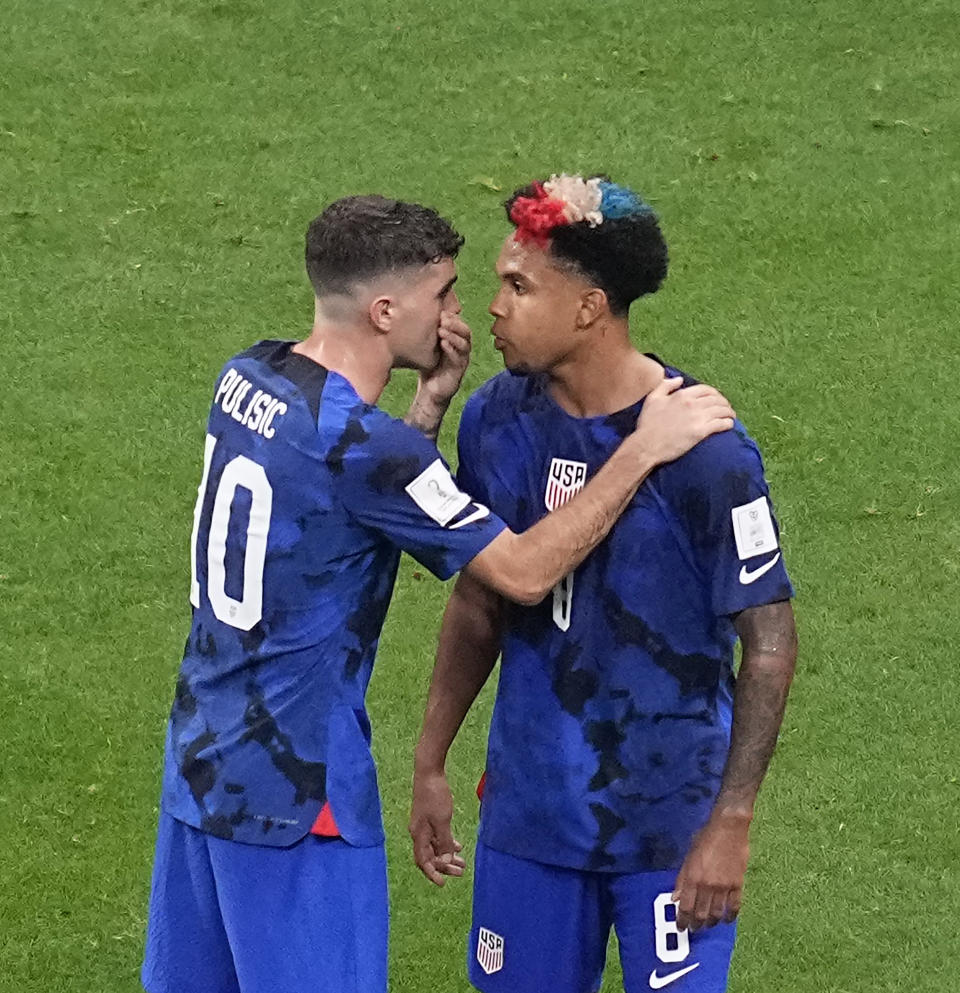 Christian Pulisic of the United States, left, speaks with teammate Weston McKennie during the World Cup group B soccer match between England and The United States, at the Al Bayt Stadium in Al Khor, Qatar, Friday, Nov. 25, 2022. (AP Photo/Ebrahim Noroozi)