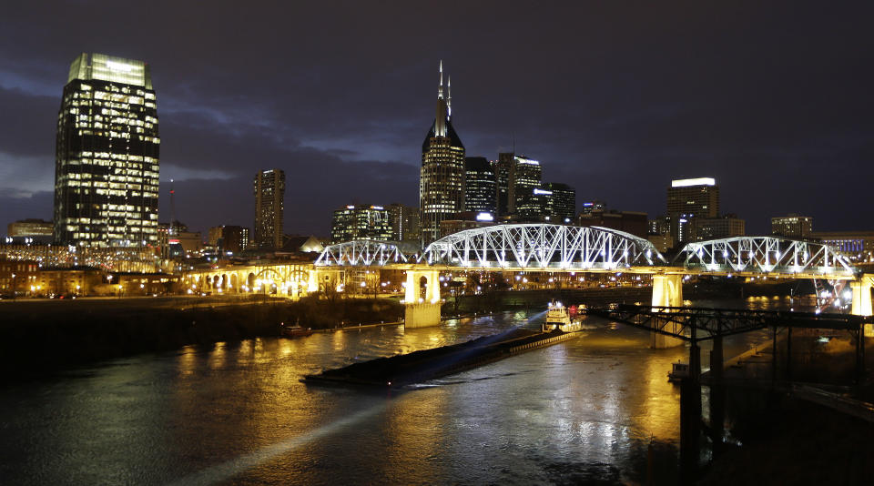 This Jan. 15, 2014 photo shows the Shelby Street pedestrian bridge spanning the Cumberland River in Nashville, Tenn. The banks of the Cumberland River in downtown Nashville are more than a place to watch barges pass. The bridge is one of the best viewpoints for the Nashville skyline that inspired Bob Dylan to write a country album. (AP Photo/Mark Humphrey)
