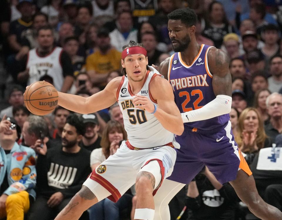 Denver Nuggets forward Aaron Gordon (50) backs down Phoenix Suns center Deandre Ayton (22) during the first quarter of the Western Conference semifinals at Ball Arena in Denver on May 9, 2023.