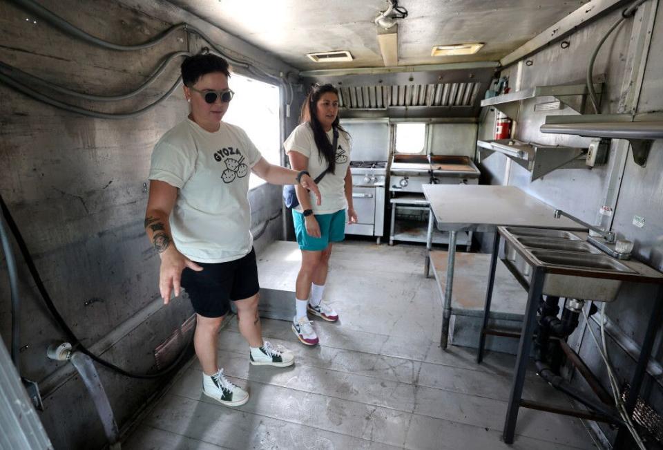 Ellie and Erika Yagi, co-owners of Yagi's Dump Truck, talk about setting up the interior of their food truck, where they will sell dumplings, in Murray on Wednesday.