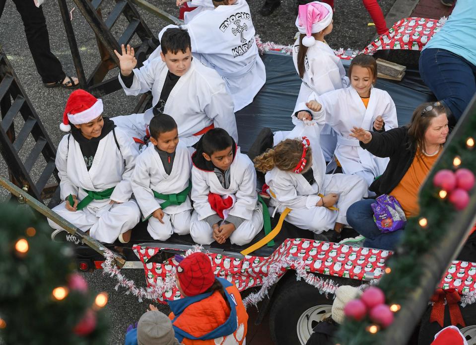 Enochs Karate members wave from their float during the 2019 City of Anderson Christmas Parade in Anderson. 