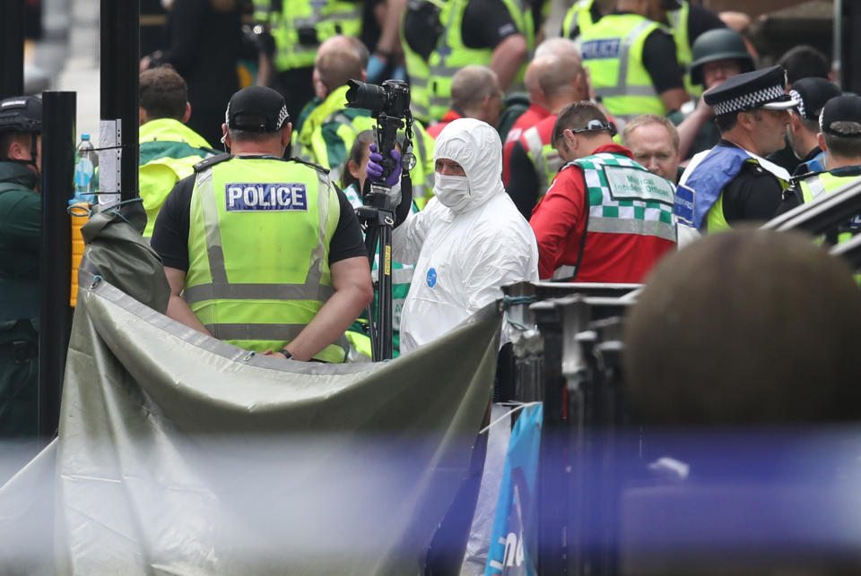 Police and forensic officers at the scene in West George Street, Glasgow. (PA)