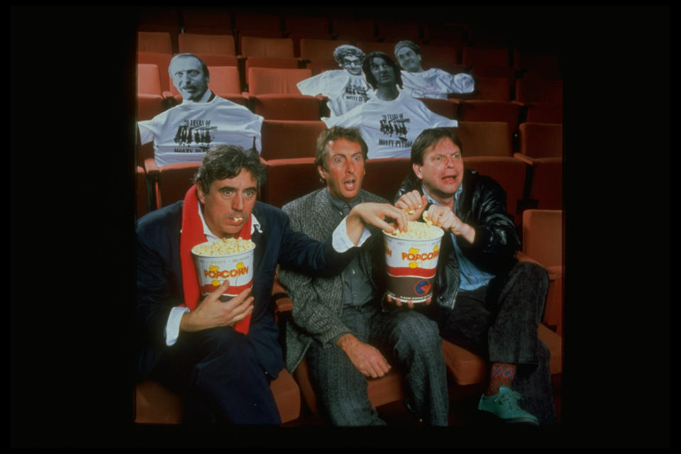 Comedians (L-R) Terry Gilliam, Eric Idle & Terry Jones eating popcorn & celebrating 20th Anniv. of Monty Python's Flying Circus; Museum of Broadcasting.  (Photo by Mario Ruiz//Time Life Pictures/Getty Images)