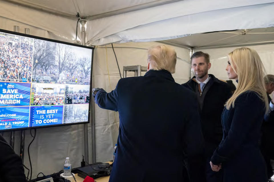 In this image released in the final report by the House select committee investigating the Jan. 6 attack on the U.S. Capitol, on Thursday, Dec. 22, 2022, President Donald Trump looks at video monitors showing the crowd gathered on the Ellipse on the morning of Jan. 6, 2021, before he spoke. At rights is Ivanka Trump and second from right is Eric Trump. (House Select Committee via AP)