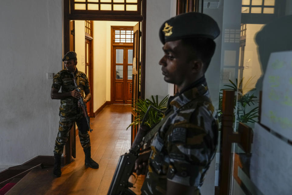 Army soldiers stand guard at prime minister Ranil Wickremesinghe's office building in Colombo, Sri Lanka, Thursday, July 14, 2022. Sri Lankan protesters retreated from government buildings they seized and military troops reinforced security at the Parliament on Thursday, establishing a tenuous calm in a country in both economic meltdown and political limbo.(AP Photo/Rafiq Maqbool)