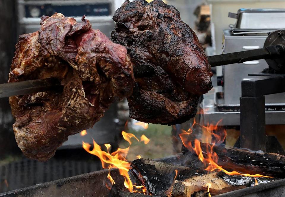 Roast beef turns on a spit above an open flame for BBQ beef sandwiches at the Benton Franklin County Fair & Rodeo in Kennewick.