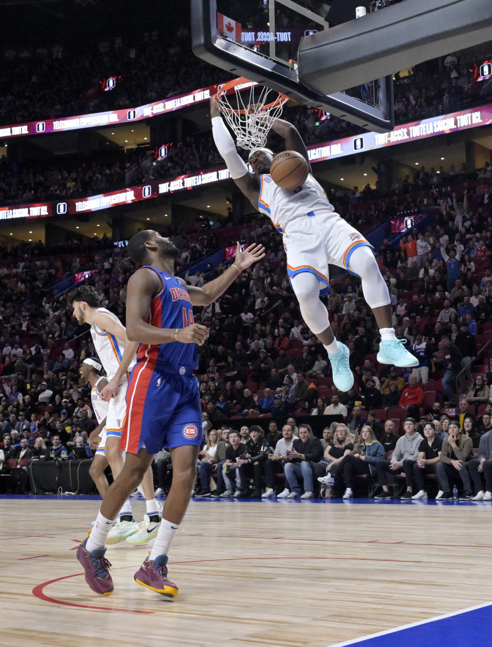 Oct 12, 2023; Montreal, Quebec, CAN; Oklahoma City Thunder guard Luguentz Dort (5) dunks the ball during the first quarter against the Detroit Pistons at the Bell Centre. Mandatory Credit: Eric Bolte-USA TODAY Sports