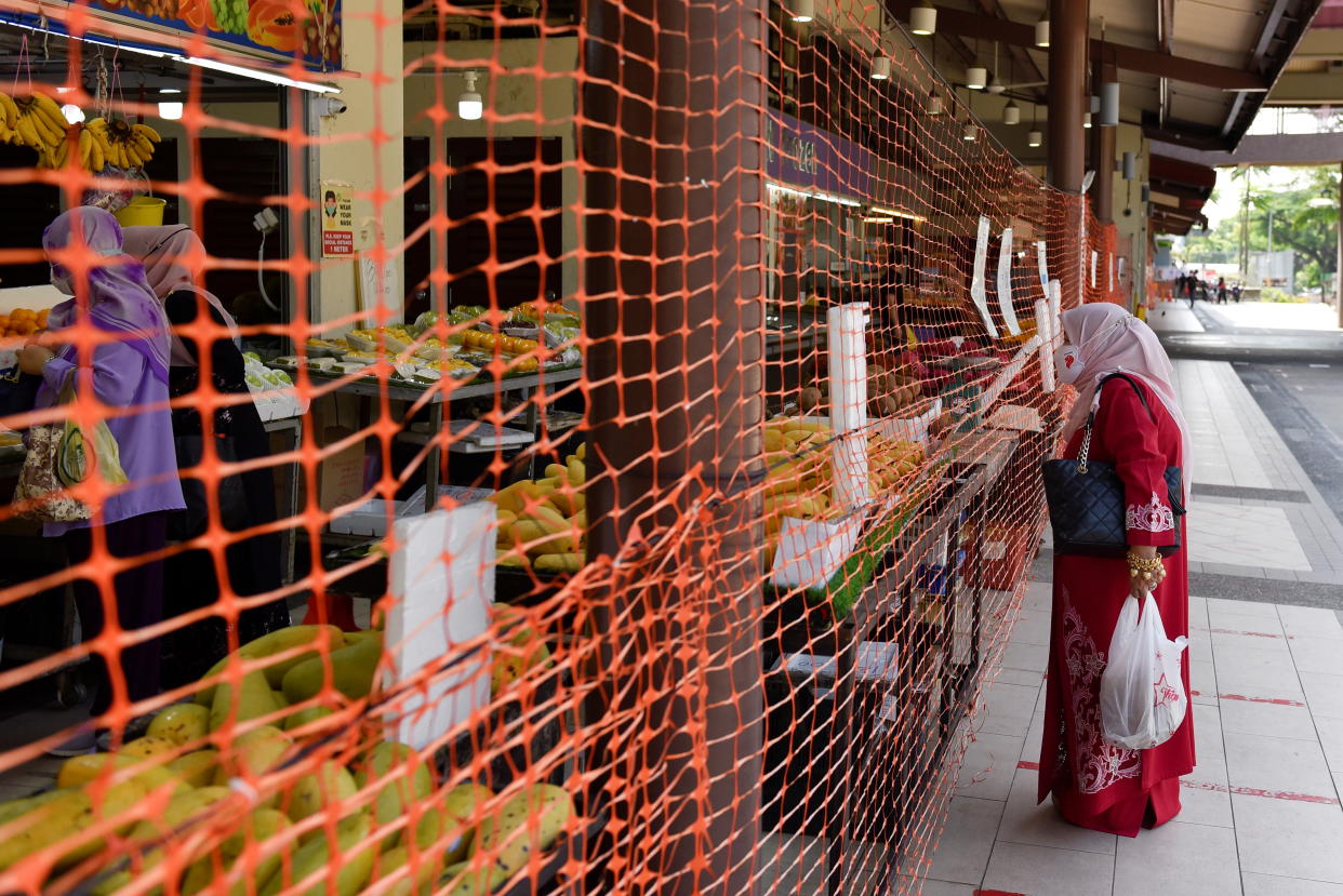 A wet market is cordoned off to limit entry and exit points after a surge in the number of coronavirus disease (COVID-19) cases in Singapore July 23, 2021. REUTERS/Caroline Chia