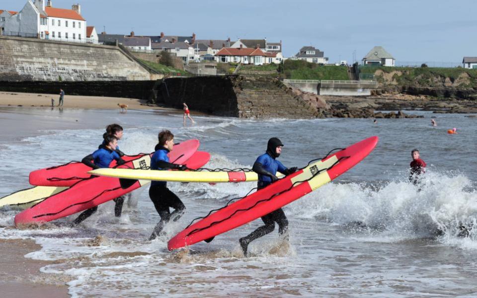 The Northern Echo: Surfboarders enjoy a freezing cold dip in the North Sea this morning (SAT) on a sunny day at