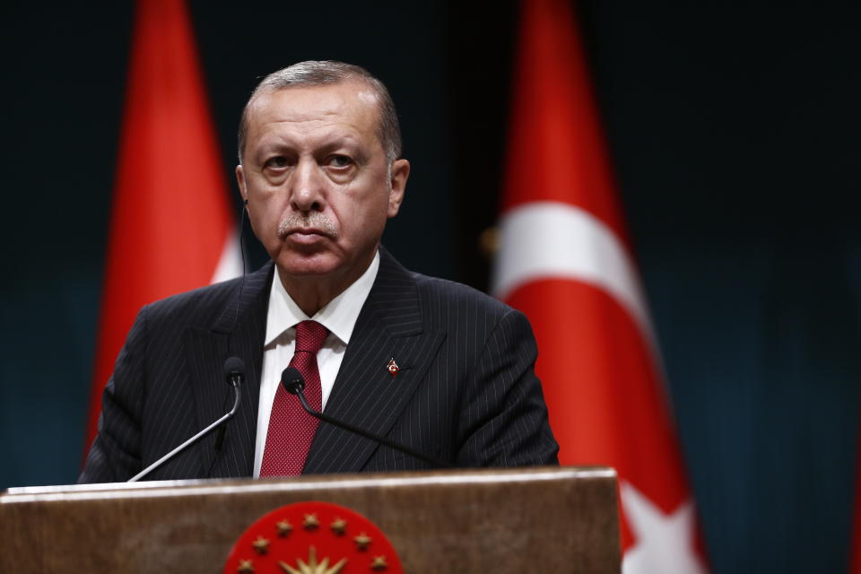 Turkey's President Recep Tayyip Erdogan listens during a joint press conference with Iraq's Prime Minister Haider al-Abadi, following their meeting at the Presidential Palace in Ankara, Turkey, Tuesday, Aug. 14, 2018. The Turkish lira has nosedived in value in the past week over concerns about Erdogan's economic policies and after the United States slapped sanctions on Turkey angered by the continued detention of an American pastor. (AP Photo/Burhan Ozbilici)