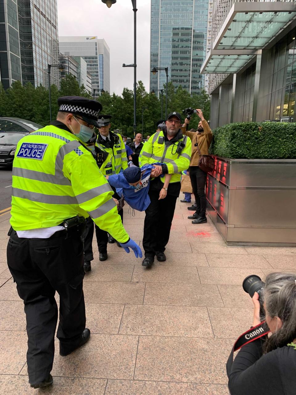 Police carry a protester away (The Independent)