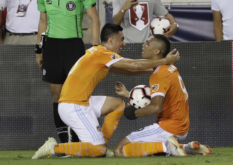 Houston Dynamo's Mauro Manotas and Memo Rodriguez celebrate after the U.S. Open Cup championship soccer match against the Philadelphia Union Wednesday, Sept. 26, 2018, in Houston. Houston Dynamo won 3-0. (AP Photo/David J. Phillip)