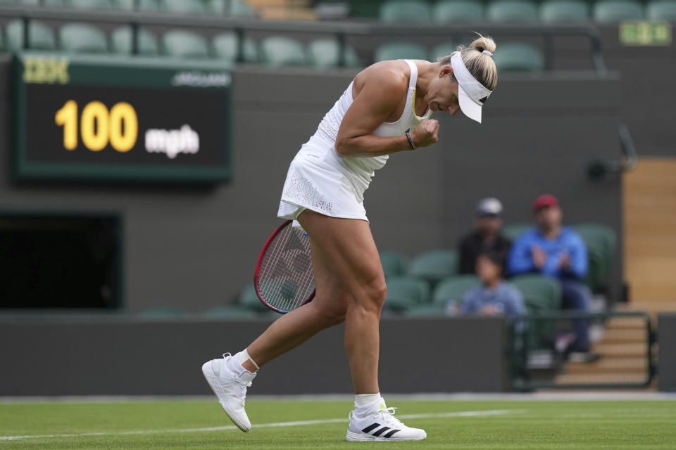 Germany's Angelique Kerber celebrates after defeating France's Kristina Mladenovic in their women's singles tennis match on day one of the Wimbledon tennis championships in London, Monday, June 27, 2022. (AP Photo/Alberto Pezzali)