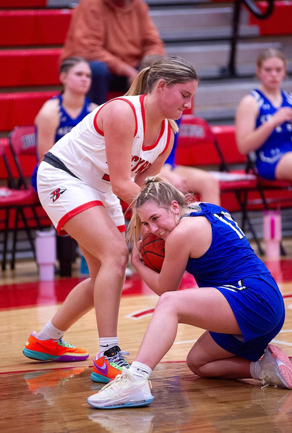 Bucyrus' Haylee Stratton and Crestline's Kennedi Sipes struggle for the ball.