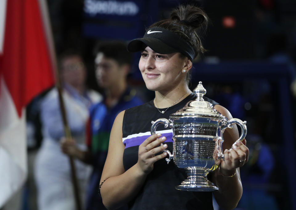 Bianca Andreescu, of Canada, holds up the championship trophy after defeating Serena Williams, of the United States, in the women's singles final of the U.S. Open tennis championships Saturday, Sept. 7, 2019, in New York. (AP Photo/Adam Hunger)