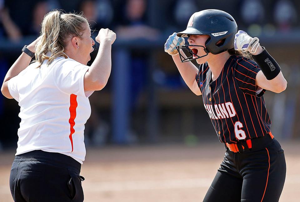 Ashland High School's Hannah Miller (6) celebrates with first base coach Michelle VanHorn after beating out a bunt single in the third inning against Springfield High School during their OHSAA Division I semifinal game Tuesday, May 17, 2022 at University of Toledo's Scott Park. Springfield won the game 10-0. TOM E. PUSKAR/TIMES-GAZETTE.COM