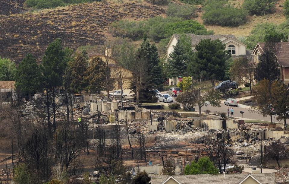 Residents of the Mountain Shadows area view their properties on Sunday, July 1, 2012, in Colorado Springs, Colo. Even people who know their homes are still standing have some anxiety over temporary visits being allowed today to wildfire-devastated neighborhoods around Colorado Springs. About 10,000 people are still out of their homes, having been among 30,000 who initially fled the most destructive fire in Colorado's history.(AP Photo/The Colorado Springs Gazette, Susannah Kay)