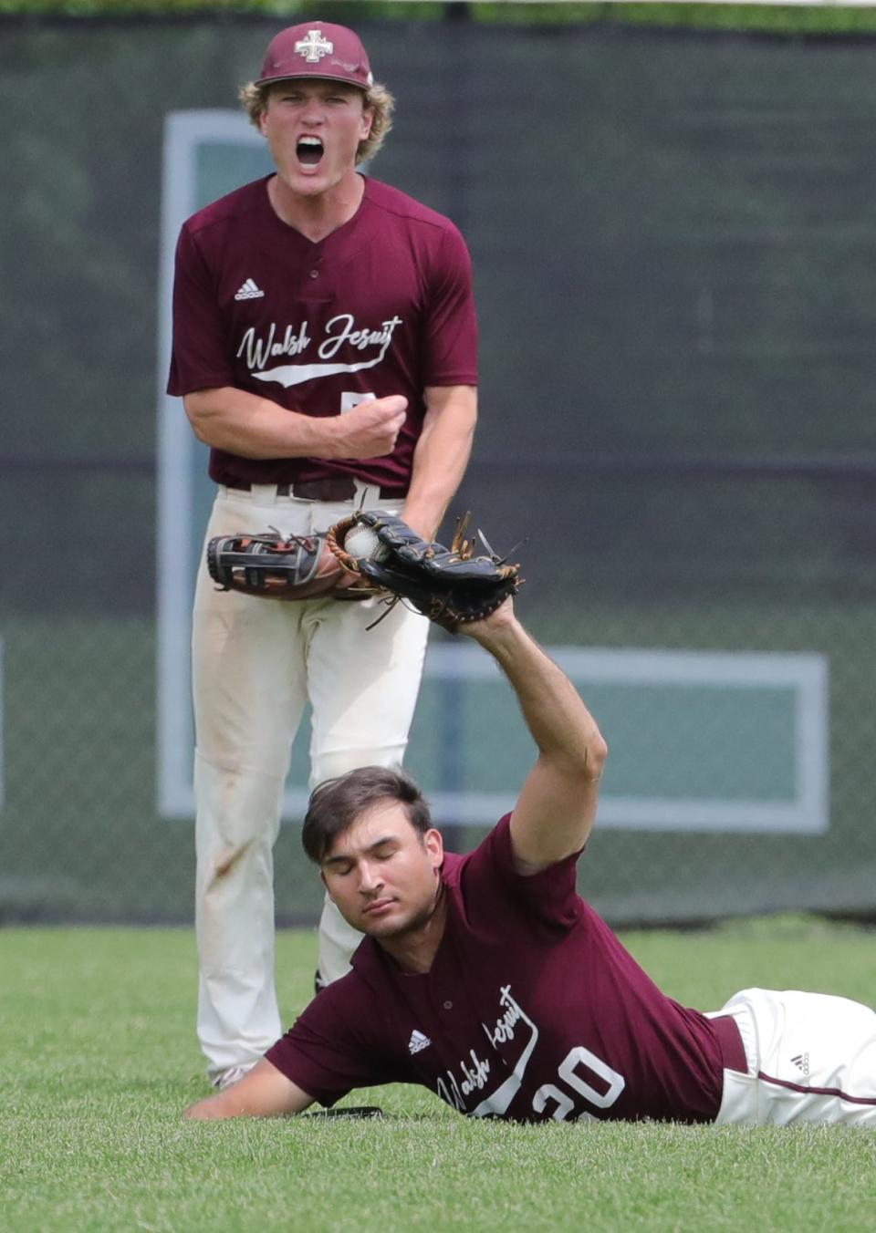 Walsh Jesuit center fielder Andrew Gormley reacts after left fielder Will Harding makes a diving catch on a ball hit by Mayfield's Matt Snider during the 5th inning of the Warriors 10-1 win in the Division I District Final on Wednesday, May 26, 2022 in Macedonia, Ohio, at Nordonia High School.