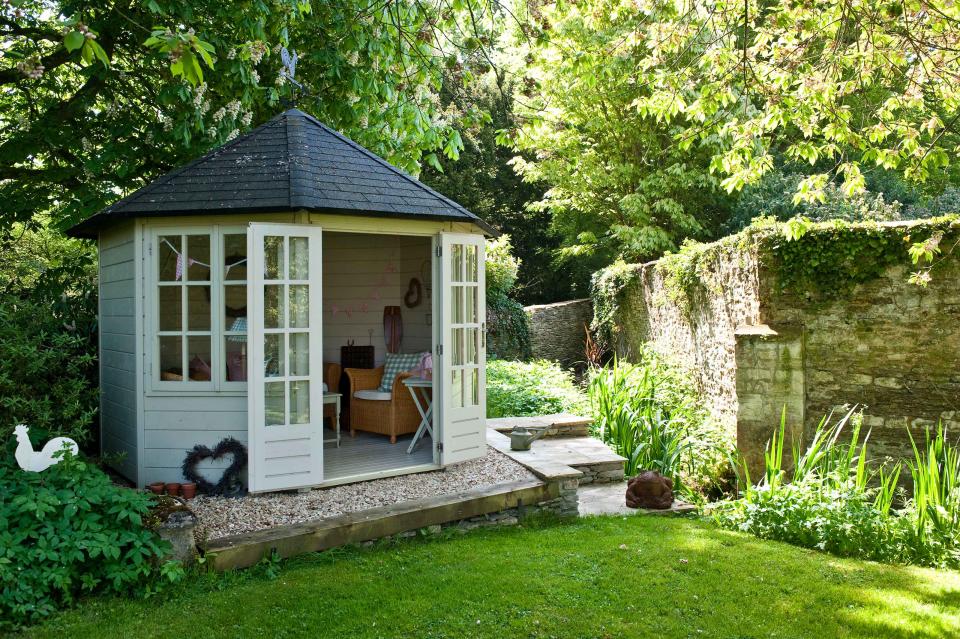 <p> Elevate your she shed ideas in the literal sense of the word by raising them up onto a levelled platform. It&apos;s an easy way to define the zone and create a striking focal point. Plus, if your garden is on a slope, it will provide the sturdy, flat base that a she shed needs. </p> <p> The gravel, stone, and wooden edge beneath the structure above gives the set-up a rustic edge, whilst tying in beautifully with the nearby steps and old stone wall. What&apos;s more, there will be lovely view of the lawn from the comfy seating inside. </p>